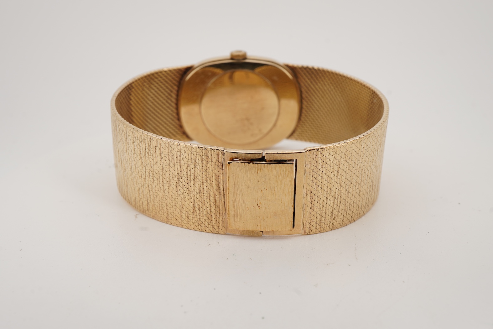 A gentleman's early 1970's 9ct gold Bueche Girod manual wind dress wrist watch, on an integral 9ct gold bark effect bracelet
